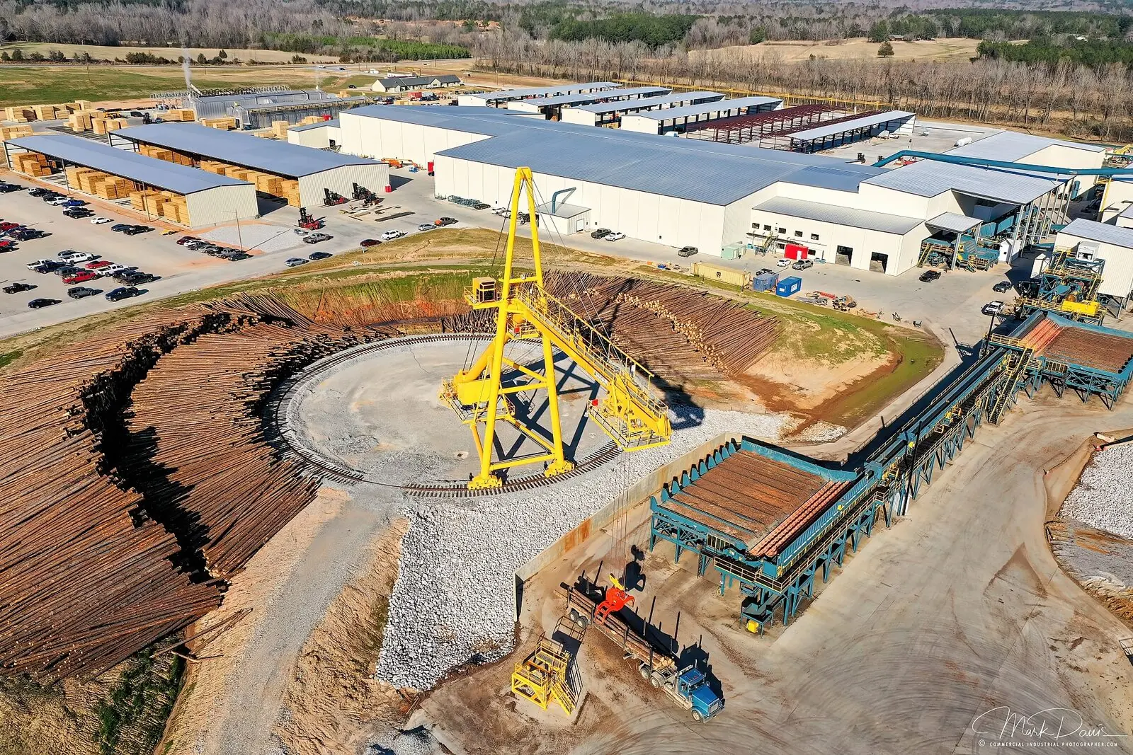 Aerial drone photograph of a lumber mill and log yard industrial facility